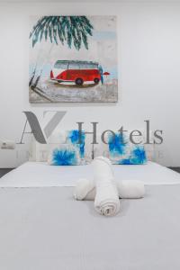 a bedroom with a white bed with a red and white car picture at A&Z El Cano - Auto check-in property in Málaga
