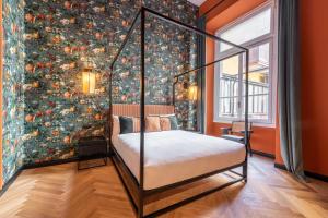 a bedroom with a bed with a floral wallpaper at DH Rooms Castello in Milan +64 photos