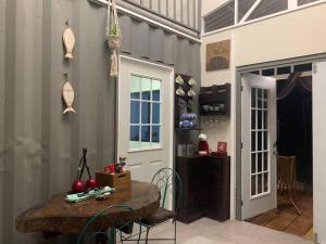 a kitchen with a wooden table and chairs in a room at Wabi Sabi , casa de playa in Tamanique