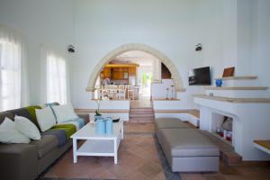 a living room with a couch and a fireplace at Ayios Elias Pearl in Protaras