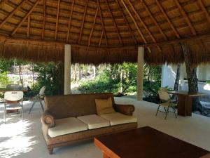 a living room with a couch and a table at Santuario Jungle in Akumal