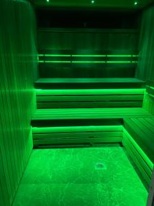 a green room with stairs with green lights at Ashbys Deluxe Studios & Spa hire in Portsmouth