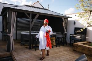 a man standing on a deck with a piano at Luxury Studios with Spa included in Portsmouth +61 photos