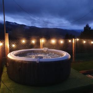 a large wooden tub sitting in a yard at night at Tiny House Colibita in Colibiţa