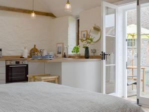 a kitchen with a bed in a room at The Chaff House in Wookey