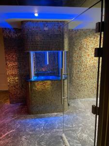 a room with a shower with a glass door at Ashbys Deluxe Studios & Spa hire in Portsmouth