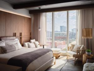 a hotel room with a bed and a large window at 1 Hotel Nashville in Nashville