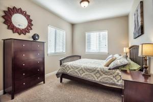 a bedroom with a bed and a dresser and a mirror at Downtown Condo Near the Convention Center in Salt Lake City