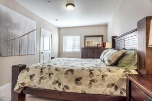 a bedroom with a large bed with a wooden headboard at Downtown Condo Near the Convention Center in Salt Lake City