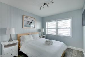 a bedroom with a white bed and a window at Silver Sands in St Pete Beach