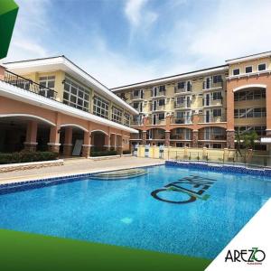 a large swimming pool in front of a building at Mikaela's Crib- 1 Bedroom flat @ Arezzo Place Condominium in Davao City