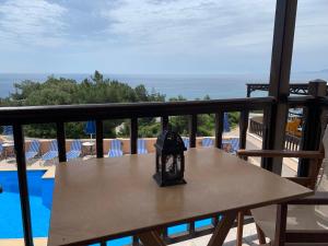 a table on a balcony with a view of the ocean at Panorama Apartments in Marathokampos