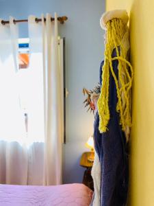 a bedroom with a bed with a yellow curtain at Panorama Apartments in Marathokampos