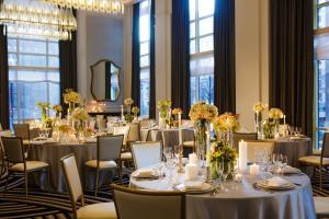 a banquet room with tables and chairs with flowers at Kimpton Hotel Monaco Pittsburgh, an IHG Hotel in Pittsburgh