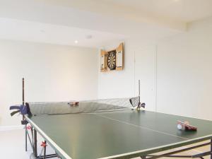 a ping pong table in a room with a ping pong ball at The Old Smithy in Llangunllo