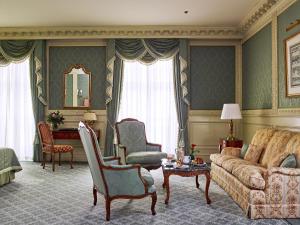 a living room with a couch and chairs and a table at Eurostars Grand Hotel Wien in Vienna