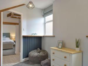 a bedroom with a bed and a dresser and a window at Warehouse Number 3 in Bridlington