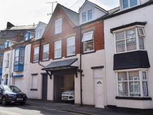 a white house with a car parked in front of it at Warehouse Number 3 in Bridlington