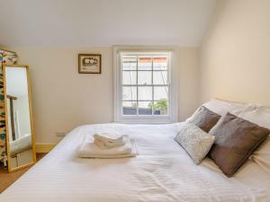 a bedroom with a white bed with a window at Top Flat-uk35142 in Lincoln