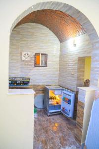 a kitchen with an open refrigerator in a room at Nubian Dreams Guest House in Aswan