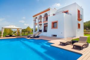 a villa with a swimming pool and a house at Villa Benimussa in Ses Paisses