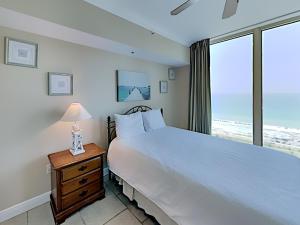 a bedroom with a large white bed and a window at Portofino Island Resort #4-1905 in Pensacola Beach +22 photos