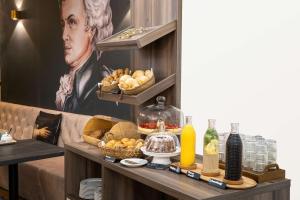 a table topped with plates of food and drinks at Arthotel ANA Amadeus in Vienna