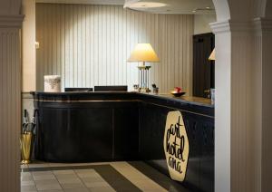 a hotel lobby with a desk with a sign on it at Arthotel ANA Gala in Vienna