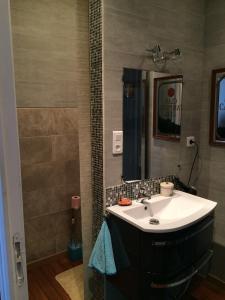 a bathroom with a sink and a mirror at Chez Pierrette in Pont-Croix