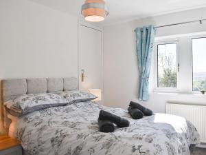 a bedroom with a bed with black tires on it at Wesley Old Hall House in Bacup