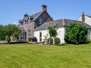 an old stone house with a picnic table in the yard at Repentance View in Carrutherstown