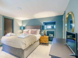 1 dormitorio con cama con espejo y escritorio en Frenchgate Mews en Richmond