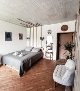 a bedroom with a bed and a chair at Cozy Studio in Palanga City Center in Palanga
