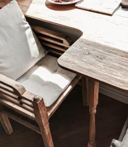 a wooden chair sitting at a wooden table at Cozy Studio in Palanga City Center in Palanga