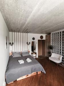 a bedroom with a large bed and a couch at Cozy Studio in Palanga City Center in Palanga