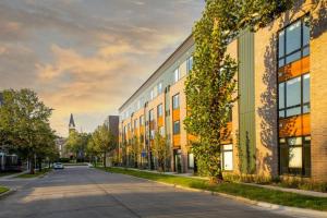 an empty street in a city with buildings at Sleepover Studio Apartments Des Moines in Des Moines