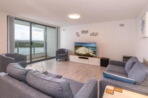 a living room with two couches and a flat screen tv at Forster Tower 44 in Forster