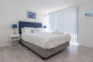 a white bedroom with a large bed and a window at Forster Tower 44 in Forster