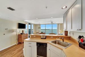 a kitchen with a sink and a view of the ocean at Tropical Paradise in Fort Myers Beach