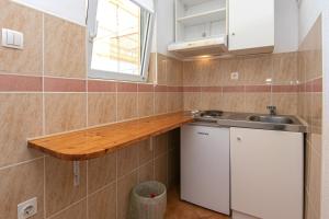 a small kitchen with a counter and a sink at Apartments with parking space Gradac, Makarska - 5198 in Gradac +60 photos