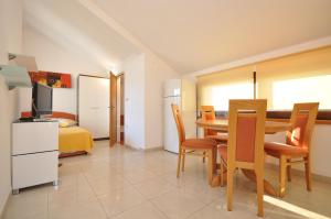 a kitchen and dining room with a table and chairs at Apartments by the sea Vela Luka, Korcula - 9243 in Vela Luka