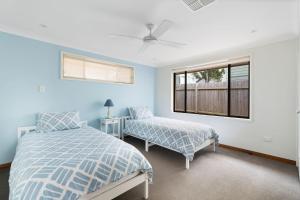 a bedroom with two beds and a window at Norah Head Seascape in Norah Head