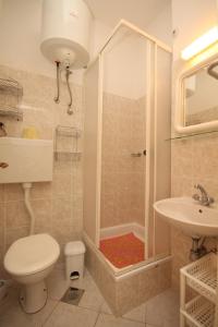 a bathroom with a shower and a toilet and a sink at Apartments by the sea Ugljan - 348 in Ugljan