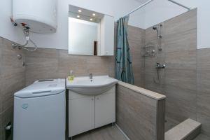 a bathroom with a sink and a shower at Apartment Gradac 14708b in Gradac