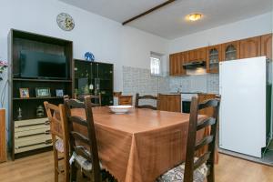 a kitchen and dining room with a table and a refrigerator at Apartment Gradac 14708b in Gradac