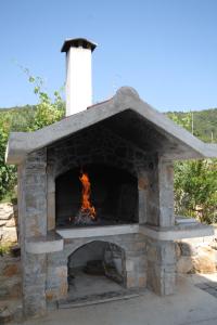 a stone oven with a fire in it at Apartments and rooms by the sea Cove Soline, Dugi otok - 448 in Veli Rat