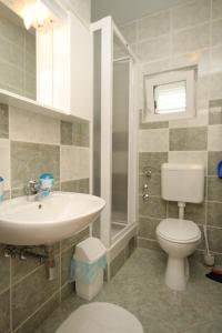 a bathroom with a white sink and a toilet at Apartments and rooms by the sea Cove Soline, Dugi otok - 448 in Veli Rat