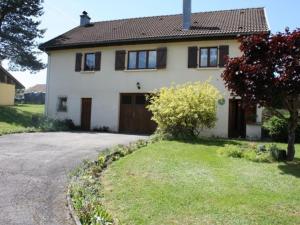 a house with a driveway in front of it at Maison tranquille avec cheminée près de Gérardmer - FR-1-589-142 in Gerbépal