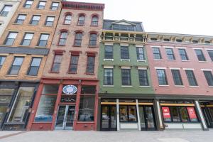 a group of tall buildings on a city street at Spacious 2 bed 2 bath Downtown OTR condo minutes walk to the Reds Bengals stadium & more! in Cincinnati