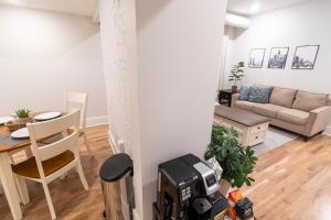 a living room with a couch and a table at Spacious 2 bed 2 bath Downtown OTR condo minutes walk to the Reds Bengals stadium & more! in Cincinnati